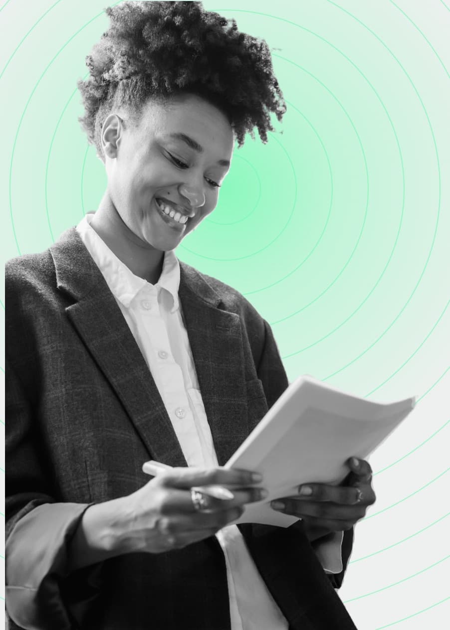 Woman smiling while reading a printed report